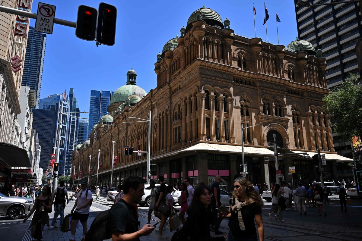 Shoppers are seen in the central business district in the run up to Christmas and New Year's Eve in Sydney on December 20, 2024. (Photo by Saeed KHAN / AFP)