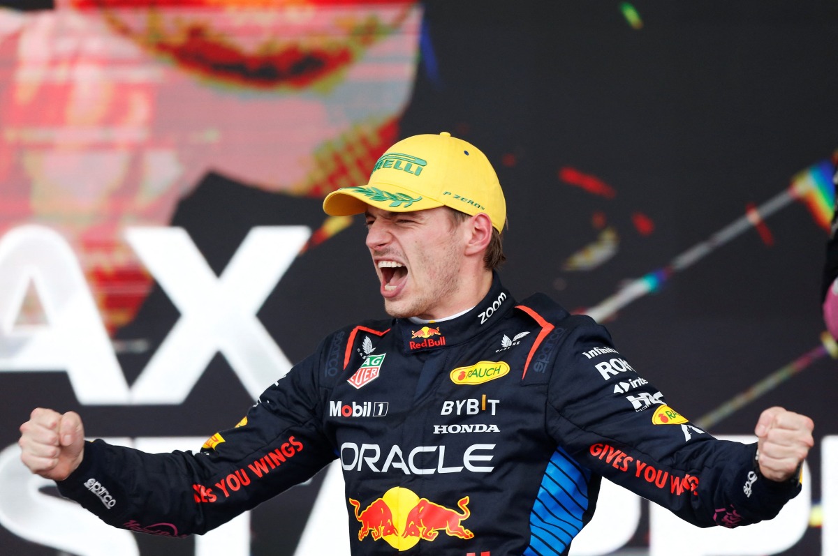 Red Bull Racing's Dutch driver Max Verstappen celebrates at the podium of the Formula One Sao Paulo Grand Prix, at the Jose Carlos Pace racetrack, aka Interlagos, in Sao Paulo, Brazil, on November 3, 2024. (Photo by Miguel Schincariol / AFP)