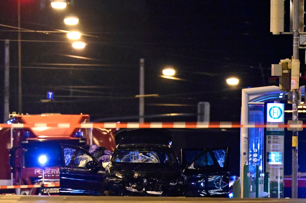 Forensics police inspect the car that crashed into a crowd at a Christmas market in Magdeburg, eastern Germany, on December 21, 2024. (Photo by John MacDougall / AFP)