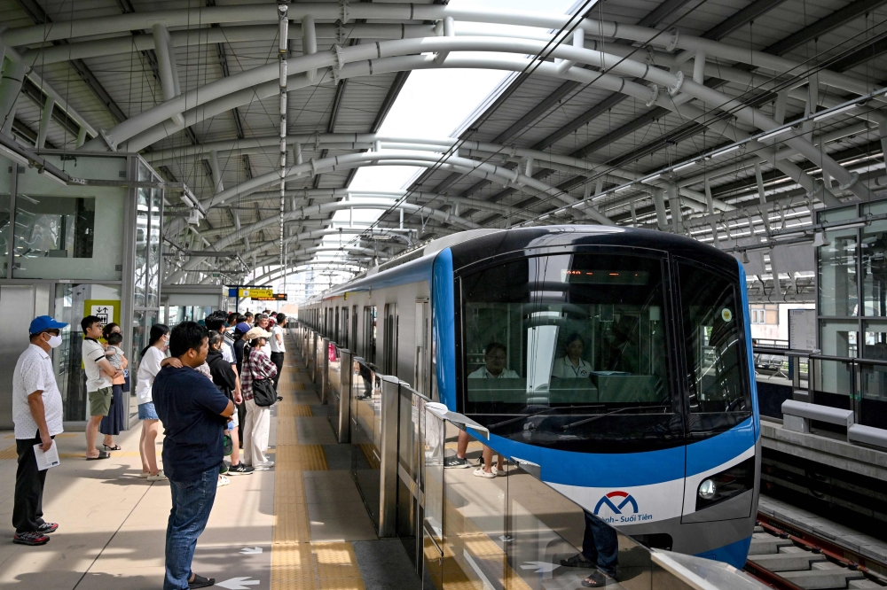 People wait to board a train at a metro station in Ho Chi Minh City on December 22, 2024. (Photo by Nhac NGUYEN / AFP)