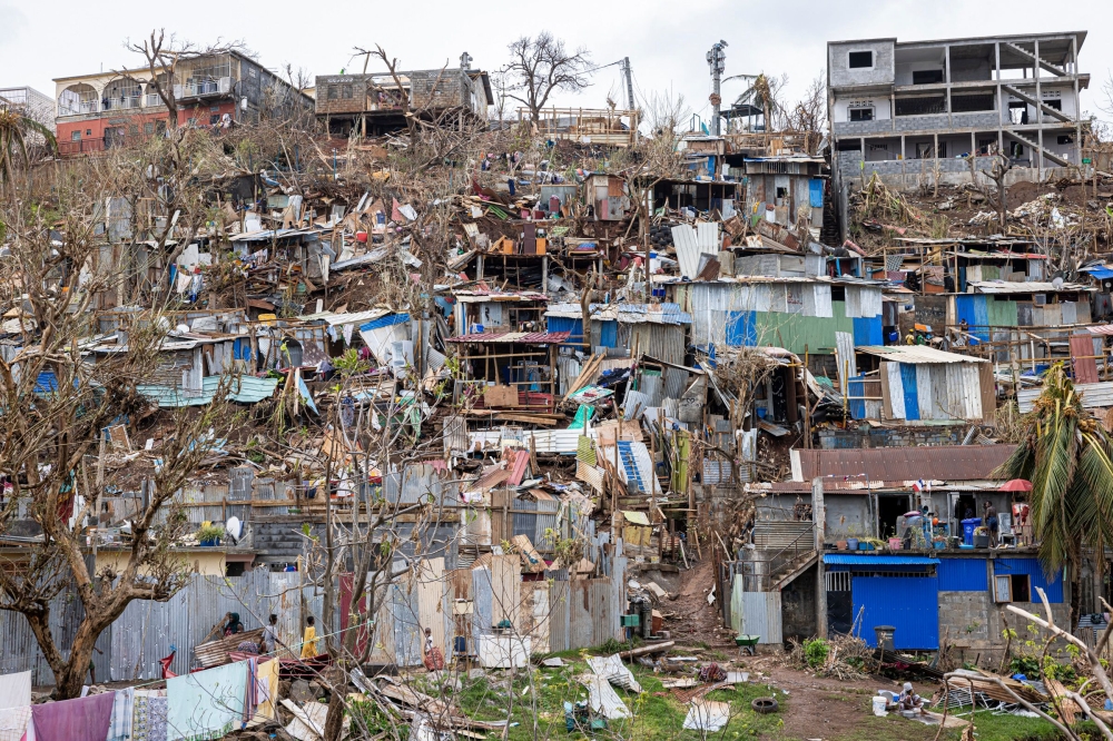 This photograph shows damaged homes in the city of Mamoudzou on the French Indian Ocean territory of Mayotte, after the cyclone Chido hit the archipelago on December 22, 2024. (Photo by Patrick Meinhardt / AFP)