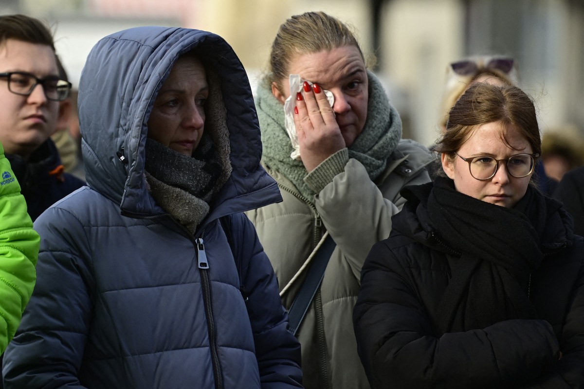 People mourn at a makeshift memorial outside the Johanniskirche (Johannes Church), near the site of a car-ramming attack on a Christmas market in Magdeburg, eastern Germany, on December 22, 2024. Photo by John MACDOUGALL / AFP.