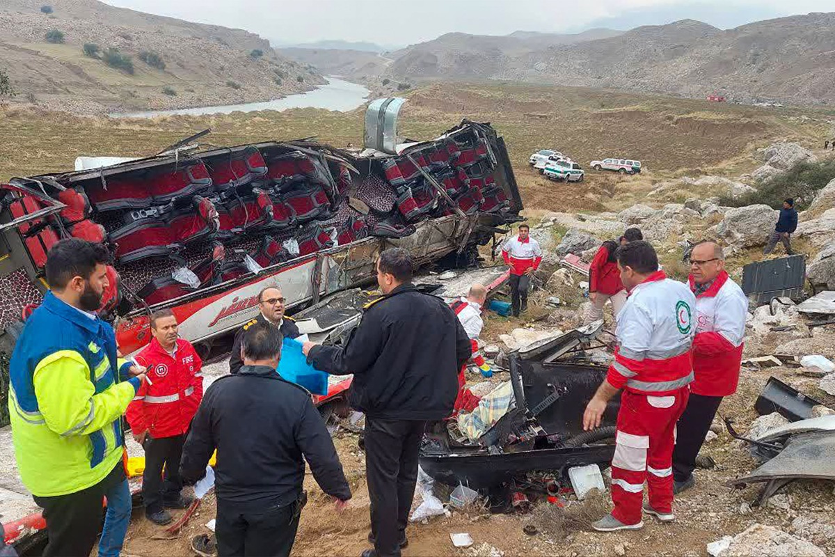 This handout picture released by the Iranian Red Crescent shows rescue workers and police officers at the scene of a fatal bus accident in the Pa-alam area on December 21, 2024. Photo by Iranian Red Crescent / AFP