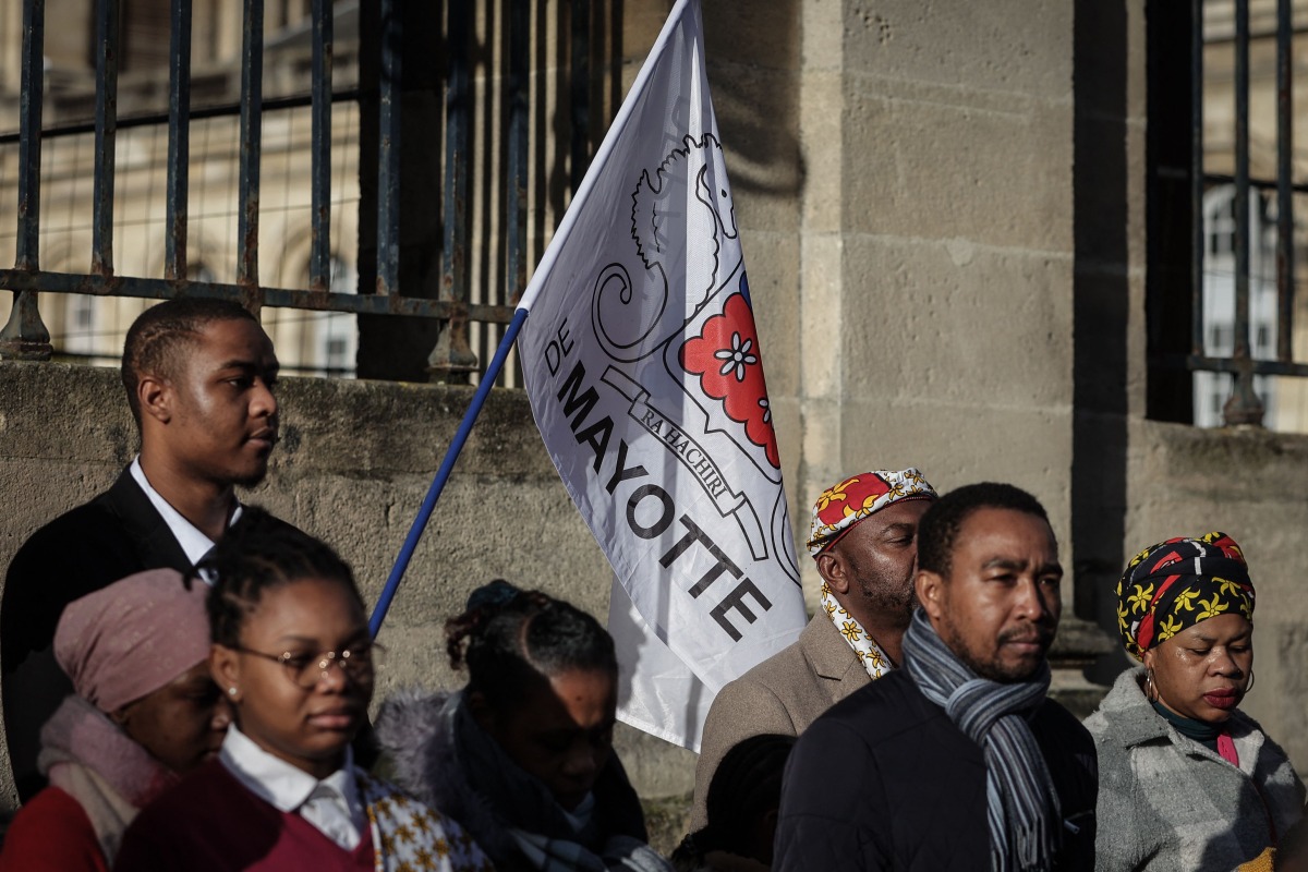 Members of the Mahoran community take part in a tribute ceremony as part of a national day of mourning for the victims of Cyclone Chido, which hit the archipelago on the French Indian Ocean territory of Mayotte a week ago, in Bordeaux on December 23, 2024. Photo by Thibaud MORITZ / AFP