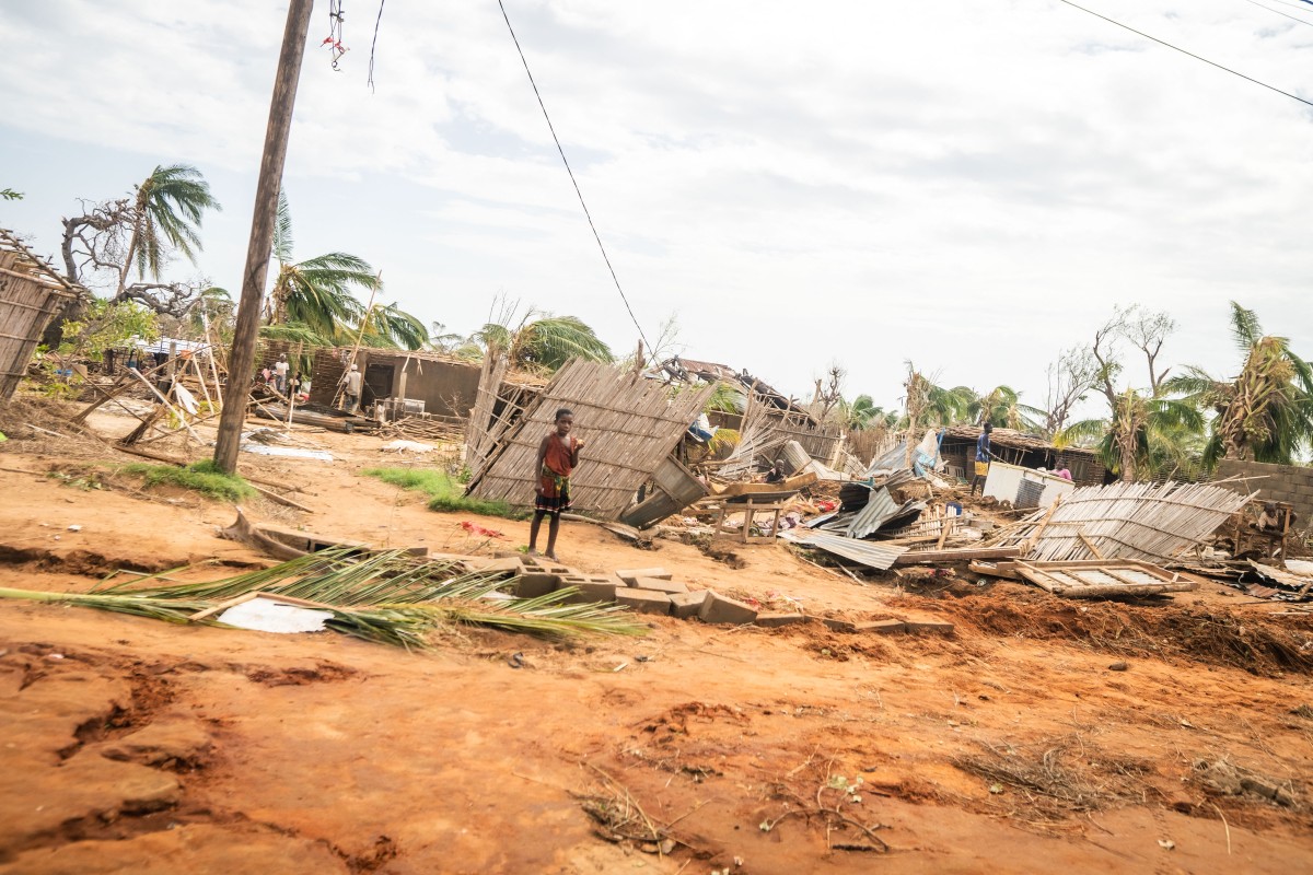 This handout picture taken and distributed by UNICEF on December 15, 2024 shows a child standing next to damaged homes after Cyclone Chido made its landfall in Mecufi district, Cabo Delgado proving, in Mozambique. Photo by Eduardo Mendes / UNICEF / AFP