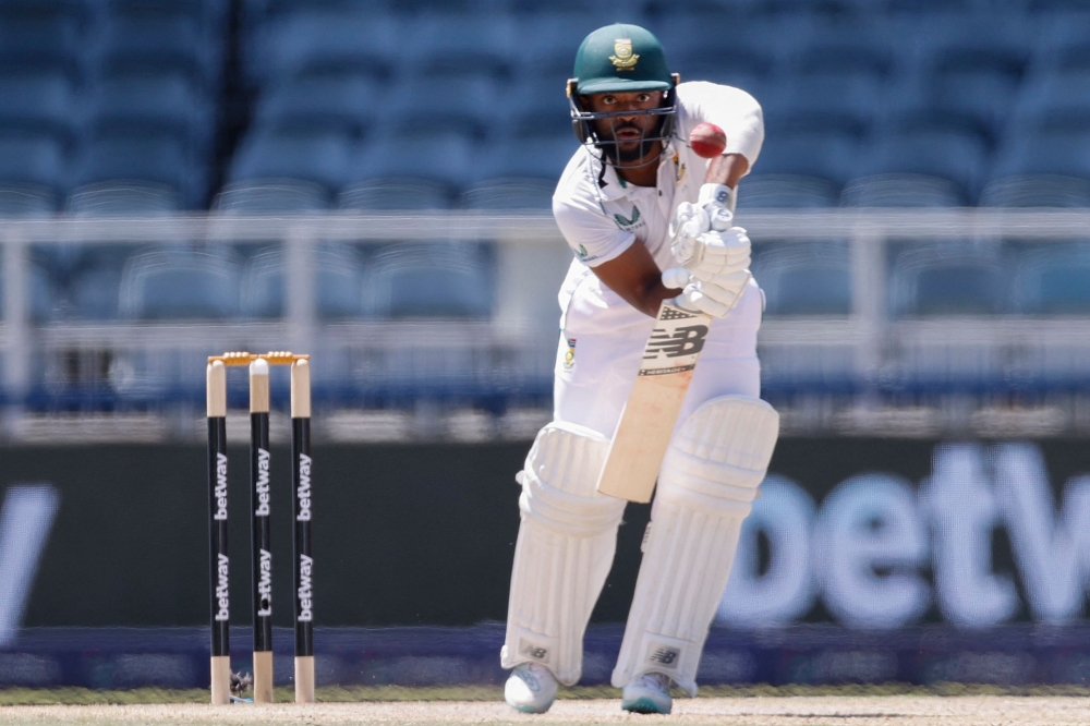 South Africa's Temba Bavuma watches the ball after playing a shot during the third day of the second Test cricket match between South Africa and West Indies at The Wanderers Stadium in Johannesburg on March 10, 2023. (Photo by PHILL MAGAKOE / AFP)