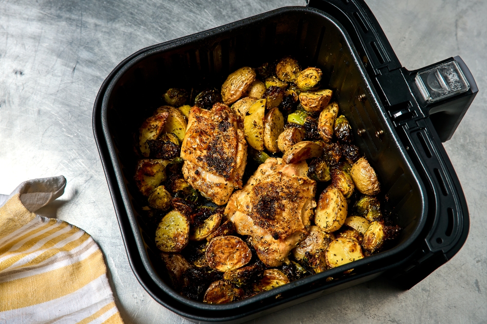 Air fryer chicken thighs with potatoes and Brussels Sprouts. (Photo by Peggy Cormary for The Washington Post)