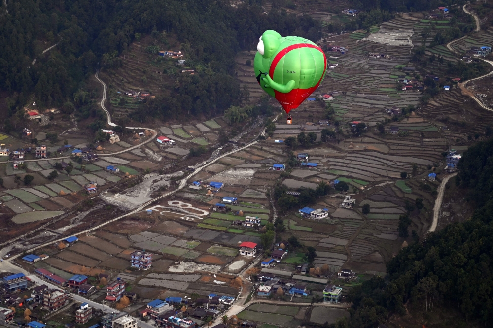 Hot air balloons rise in the sky during the International Hot-Air Balloon festival in Pokhara on December 24, 2024. (Photo by PRAKASH MATHEMA / AFP)
 