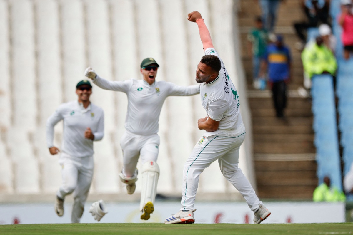 South Africa's Dane Paterson (R) celebrates with teammates after the dismissal of Pakistan's Salman Agha (unseen), and his fifth wicket for the day, during the first day of the first cricket Test match between South Africa and Pakistan at SuperSport Park in Centurion on December 26, 2024. (Photo by PHILL MAGAKOE / AFP)