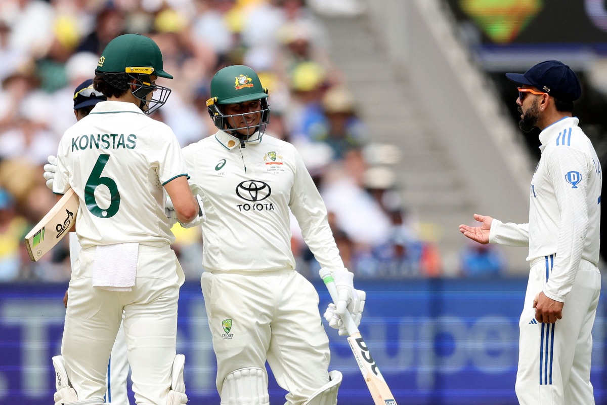 Australia's Sam Konstas (L) chats with India's Virat Kohli (R) on day one of the fourth cricket Test match between Australia and India at the Melbourne Cricket Ground (MCG) in Melbourne on December 26, 2024. (Photo by Martin KEEP / AFP) 