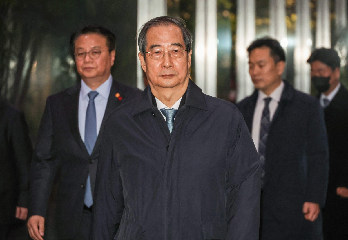 South Korea's Prime Minister Han Duck-soo (C) leaves the Government Complex in Seoul on December 27, 2024, after his impeachment motion was passed by the National Assembly.