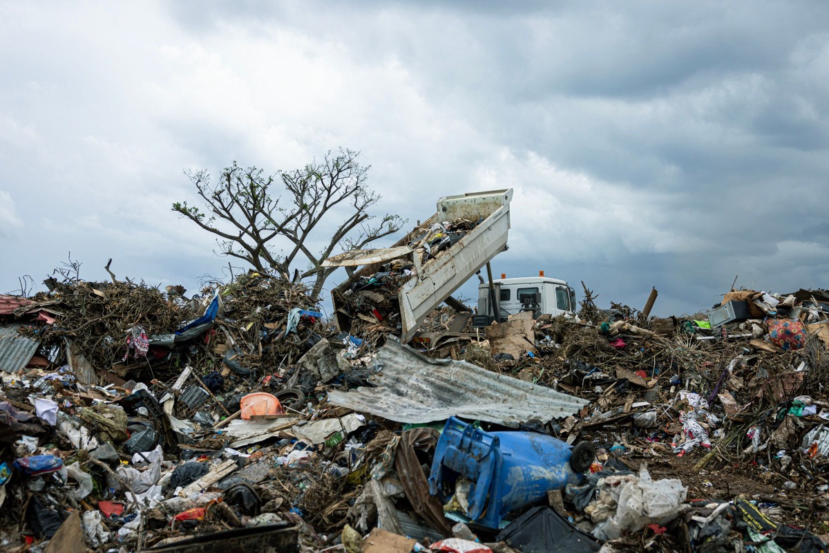 This photograph shows a truck unloading a garbages in a waste disposal site in the city of Tsountsou, on the French Indian Ocean territory of Mayotte on December 26, 2024. Photo by PATRICK MEINHARDT / AFP