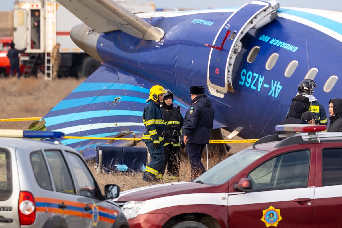 Emergency specialists work at the crash site of an Azerbaijan Airlines passenger jet near the western Kazakh city of Aktau on December 25, 2024. Photo by Issa Tazhenbayev / AFP