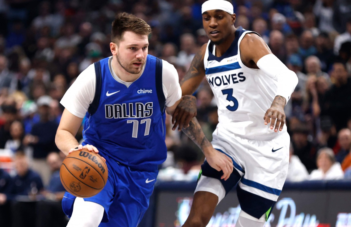 Luka Doncic #77 of the Dallas Mavericks handles the ball as Jaden McDaniels #3 of the Minnesota Timberwolves defends in the first half at American Airlines Center on December 25, 2024 in Dallas, Texas. Photo by Ron Jenkins / GETTY IMAGES NORTH AMERICA / Getty Images via AFP