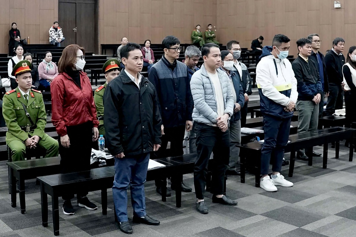 Vietnamese officials accused of corruption over repatriation flights at the start of the Covid-19 pandemic stand during their trial at the Hanoi People's Court in Hanoi on December 24, 2024. Photo by AFP