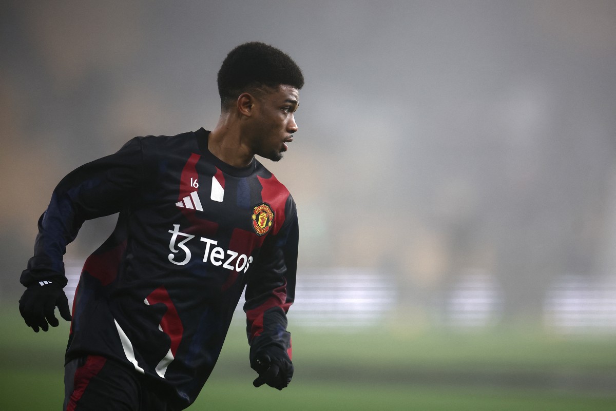 Manchester United's Ivorian midfielder #16 Amad Diallo warms up ahead of the English Premier League football match between Wolverhampton Wanderers and Manchester United at the Molineux stadium in Wolverhampton, central England on December 26, 2024. (Photo by HENRY NICHOLLS / AFP)