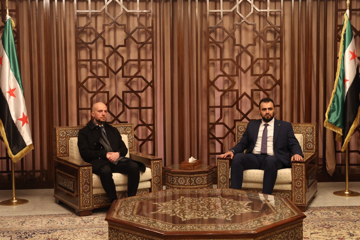 Protocol chief in Syria's new ministry of foreign affairs, Qutaiba Qadish (R), meets with minister of state for communication and political affairs Walid Ellafi from Libya's UN-recognised government in Damascus on December 28, 2024. Photo by OMAR HAJ KADOUR / AFP.