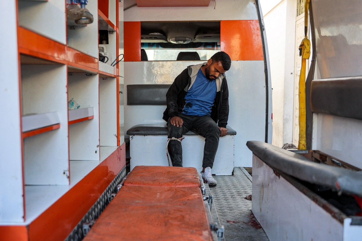 A man who was injured in a reported strike on a Palestinian civilian vehicle by Israeli forces, sits in an ambulance in Gaza City on December 22, 2024. Photo by Omar AL-QATTAA / AFP.
