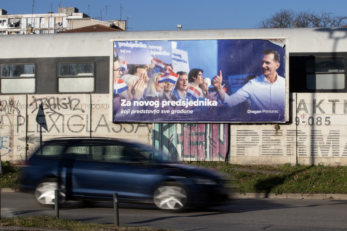 A car drives past an election poster of Presidential candidate of the Croatian Democratic Union (HDZ) party, Dragan Primorac that reads 