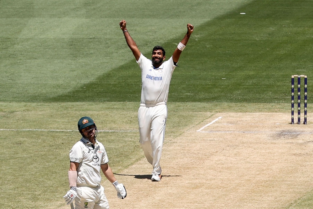 India's Jasprit Bumrah (C) celebrates the wicket of Australia's Mitchell Marsh (C) on day four of the fourth cricket Test match between Australia and India at the Melbourne Cricket Ground (MCG) in Melbourne on December 29, 2024. (Photo by Martin KEEP / AFP) 