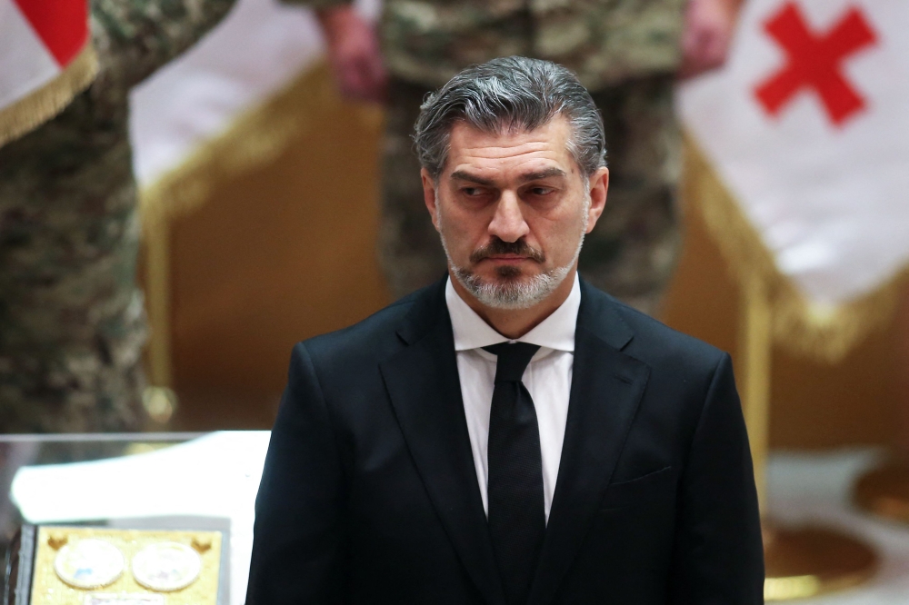 Mikheil Kavelashvili, elected by lawmakers as Georgia's new President, takes the oath during his swearing-in ceremony at the parliament in Tbilisi, on December 29, 2024. (Photo by Irakli Gedenidze / Pool / AFP)