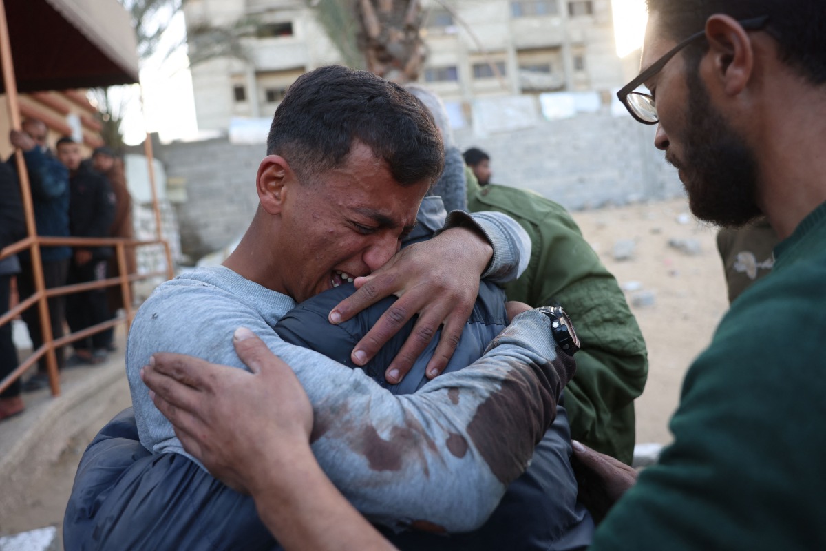 A Palestinian man mourns a relative, killed in an Israeli strike, at the Nasser Hospital in Khan Yunis in the southern Gaza Strip on December 28, 2024. (Photo by BASHAR TALEB / AFP)
 