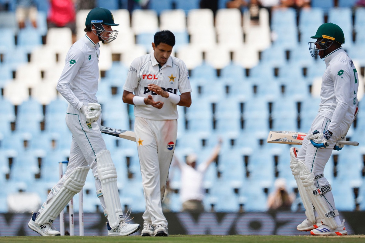 Pakistan's Mohammad Abbas (C) applauds as South Africa's Marco Jansen (L) and South Africa's Kagiso Rabada (R) celebrate South Africa winning the match during the fourth day of the first cricket Test match between South Africa and Pakistan at SuperSport Park in Centurion on December 29, 2024. (Photo by PHILL MAGAKOE / AFP)
