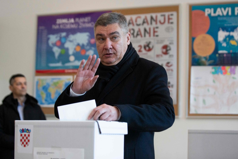 Croatia's outgoing President and Social Democratic Party (SDP) presidential candidate Zoran Milanovic casts his ballot to vote in the country's presidential elections at a polling station in Zagreb on December 29, 2024. (Photo by AFP)
