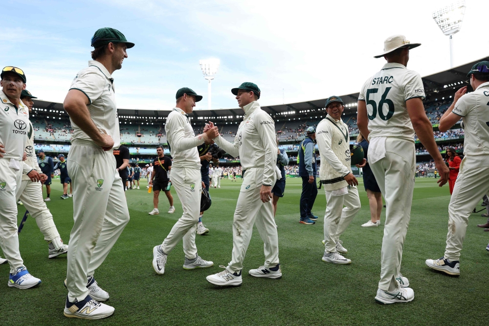 Australian players celebrate after winning the match on day five of the fourth cricket Test match between Australia and India at the Melbourne Cricket Ground (MCG) in Melbourne on December 30, 2024. (Photo by Martin Keep / AFP)