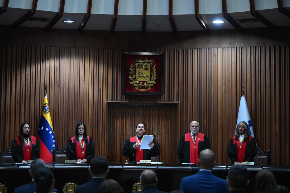 The second vice president of Venezuela's Supreme Court of Justice (TSJ), Tania D'Amelio (C), speaks about a fine imposed on the social network TikTok at the TSJ building in Caracas on December 30, 2024. (Photo by Federico Parra / AFP)