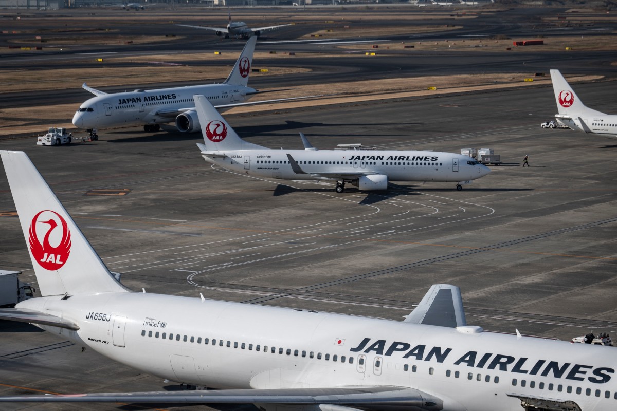 Japan Airlines passenger planes are seen on the tarmac at Haneda Airport in Tokyo on December 26, 2024. Photo by Yuichi YAMAZAKI / AFP.