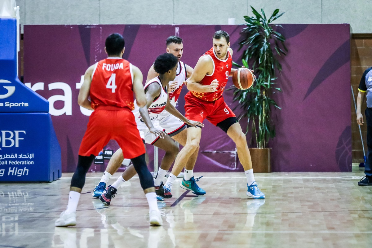 Al Arabi’s Elmedin Kikanovic  (right) is challenged by Al Rayyan players.