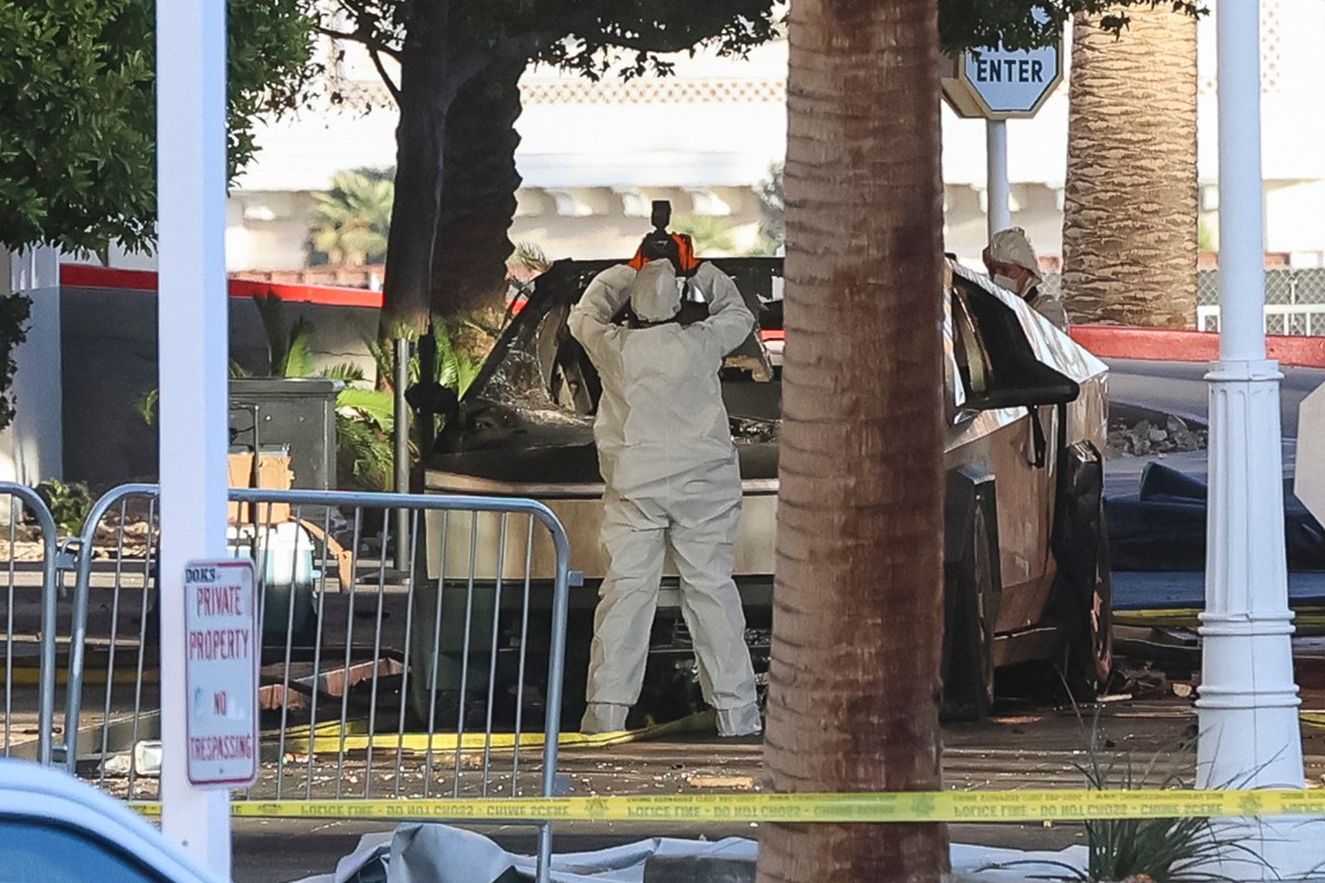 An investigator photographs a Tesla Cybertruck that exploded outside the lobby of President-elect Donald Trump's hotel on January 1, 2025, in Las Vegas. Photo by WADE VANDERVORT / AFP.