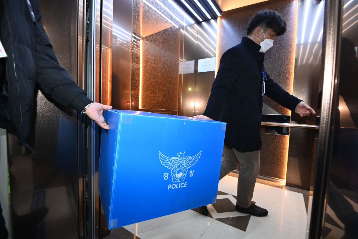 Police officers conduct a raid at Muan International Airport in Muan, some 288 kilometres southwest of Seoul on January 2, 2025. Photo by YONHAP / AFP