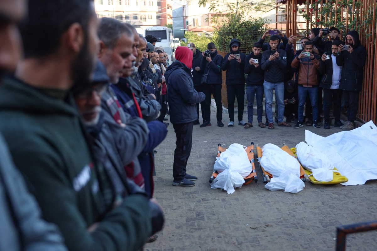 People recite a prayer over the bodies of displaced Palestinians killed in an overnight Israeli strike on a makeshift displacement camp in Mawasi Khan Yunis in the southern Gaza Strip, in the yard of the Nasser hospital on January 2, 2025. Photo by BASHAR TALEB / AFP