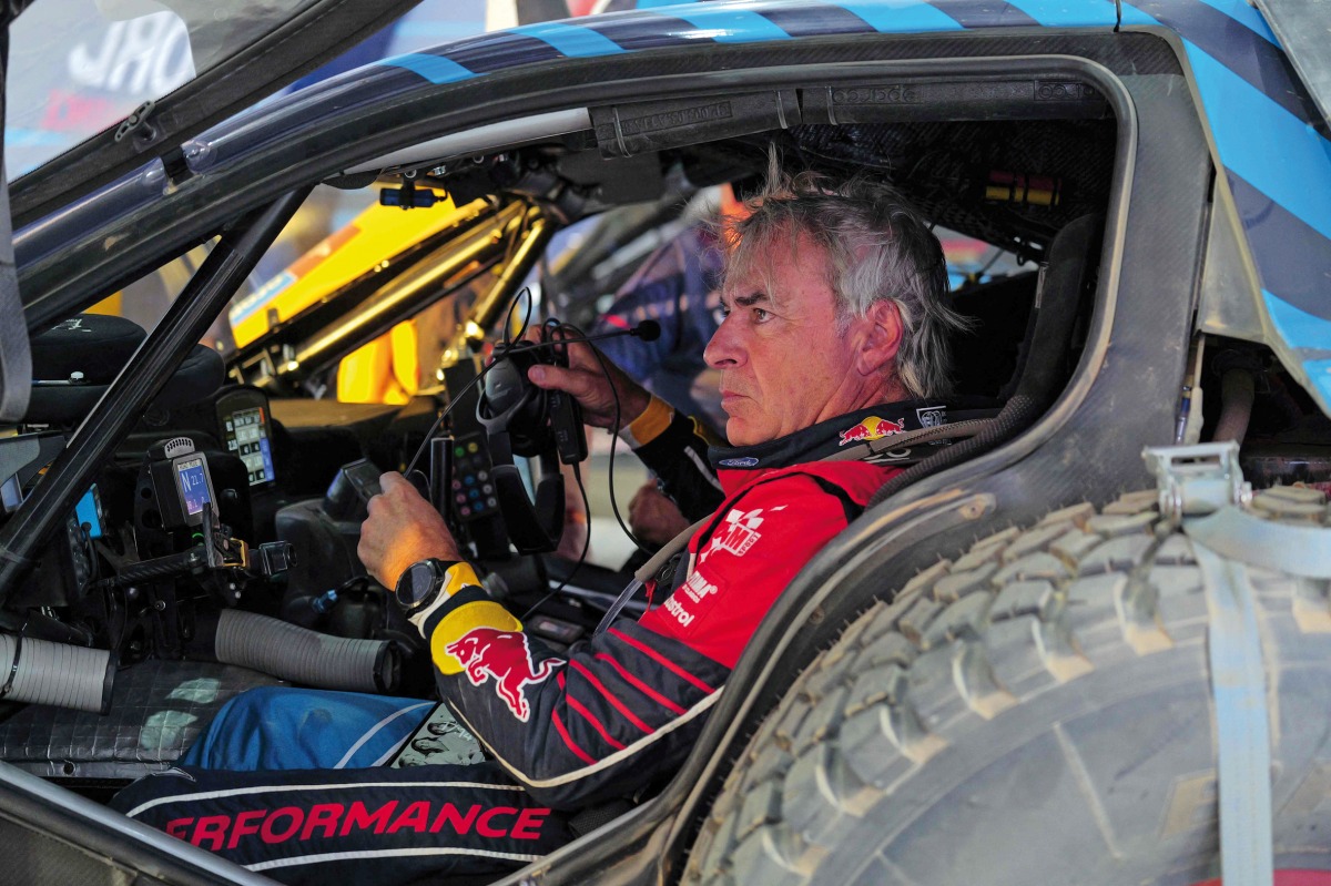 Ford M-Sport’s Spanish Driver Carlos Sainz sits inside his car after a practice session ahead of the Dakar Rally 2025, in Bisha.