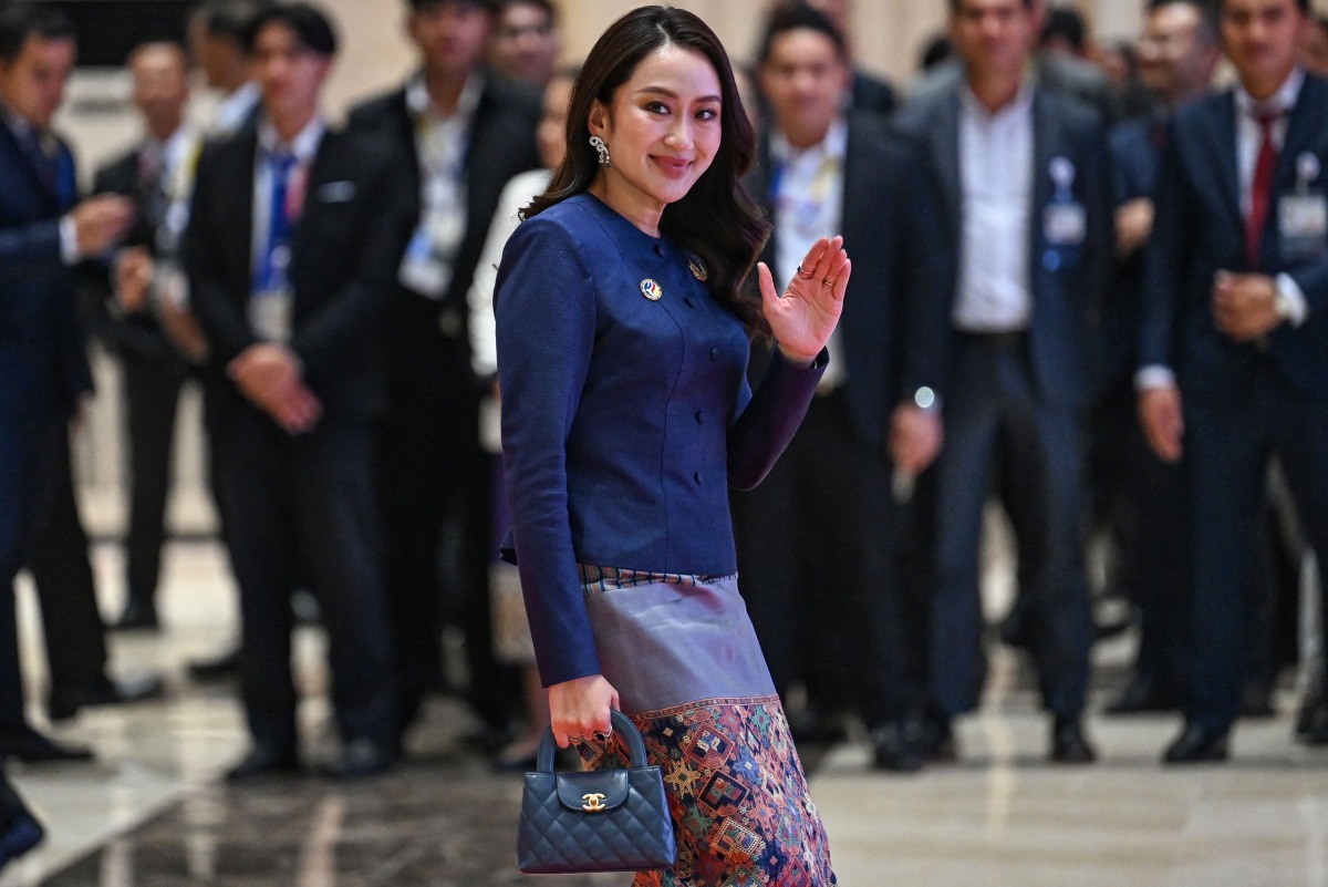 Thailand's Prime Minister Paetongtarn Shinawatra holds a handbag as she arrives to attend the gala dinner during the 44th and 45th Association of Southeast Asian Nations (ASEAN) Summits in Vientiane on October 10, 2024. Photo by TANG CHHIN SOTHY / POOL / AFP