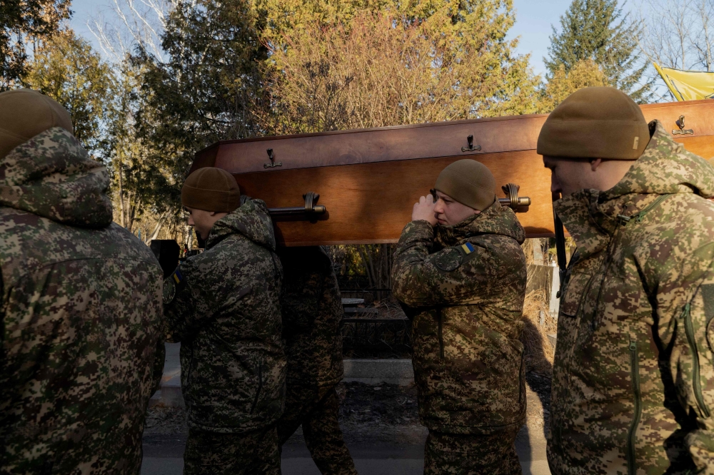 Ukrainian soldiers carry the coffin of late Ukrainian serviceman Danylo Bobrykov, callsign 