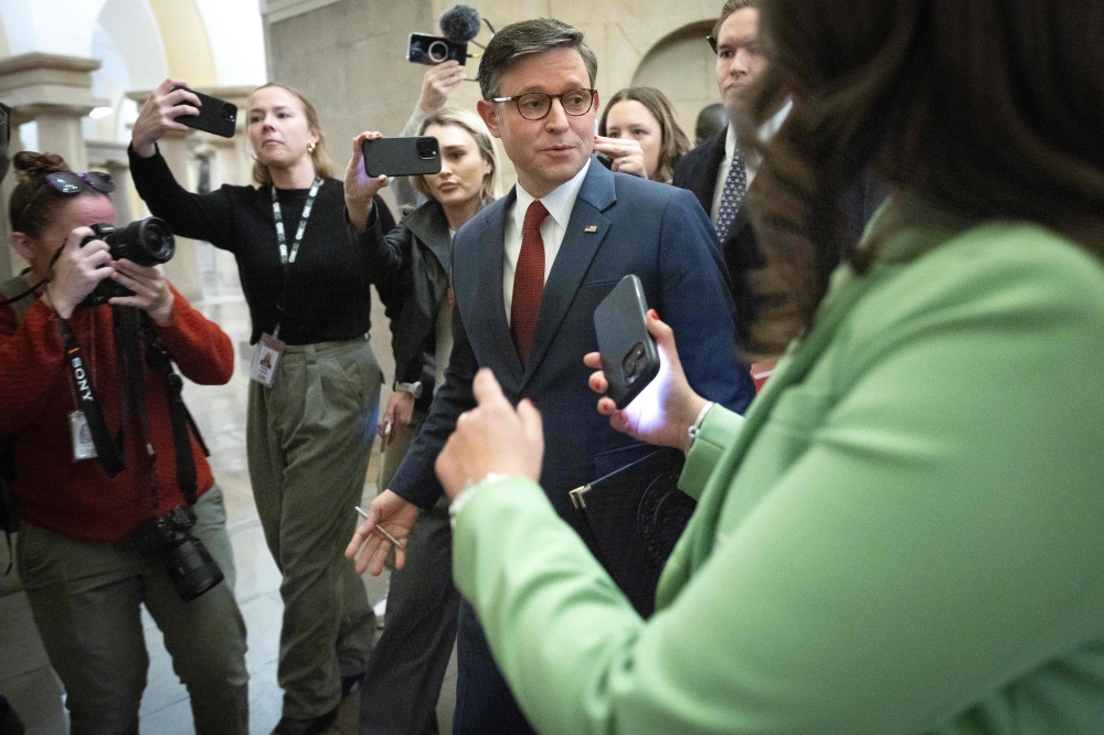 US Speaker of the House Mike Johnson talks with members of the media while walking to his office on January 03, 2025 in Washington, DC. (Photo by Win McNamee/Getty Images via AFP)