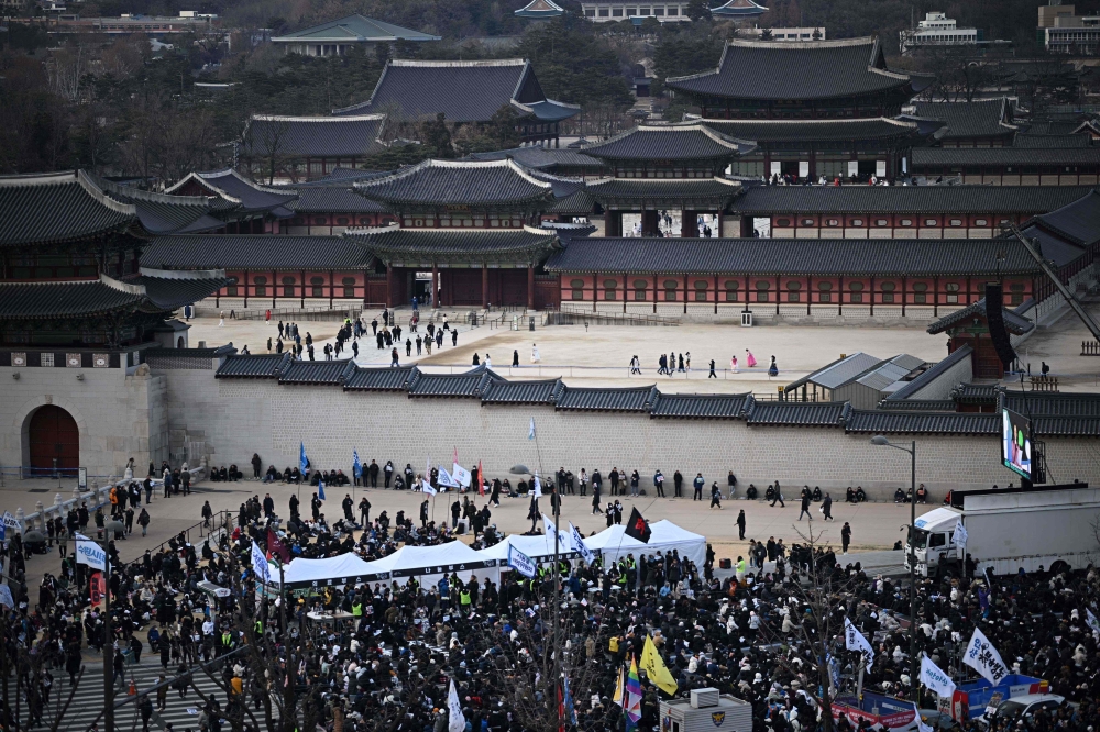 People gather for a rally to protest against impeached South Korea's president Yoon Suk Yeol is seen in front of the Gwanghwamun Gate in Seoul on January 4, 2025. (Photo by Philip FONG / AFP)