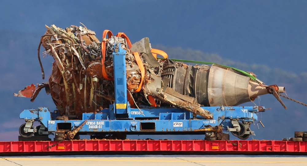 The salvaged second engine of the Jeju Air Boeing 737-800 aircraft is seen after the plane crashed and burst into flames at Muan International Airport, in Muan on January 4, 2025. (Photo by YONHAP / AFP) 