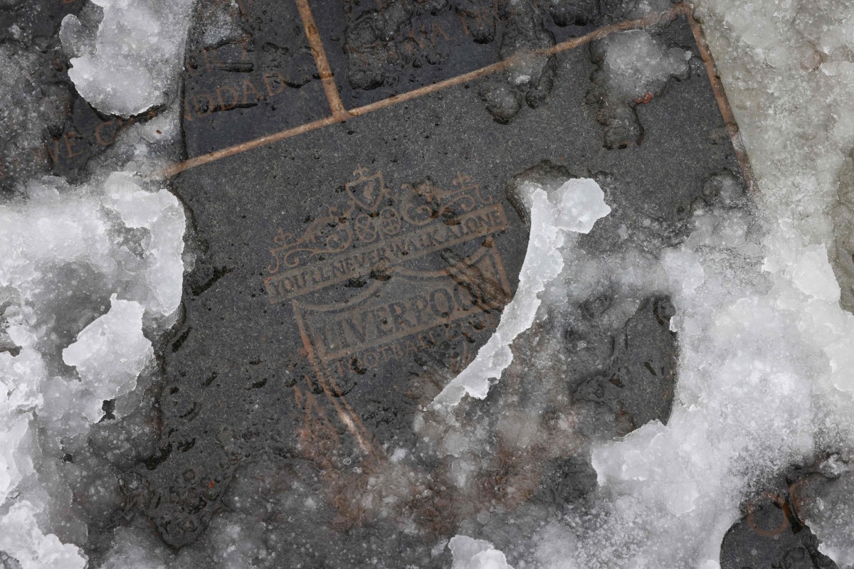 A photograph taken on January 5, 2025, shows Snows of pavement outside Anfield in Liverpool, north west England on January 5, 2025. (Photo by Darren Staples / AFP) 