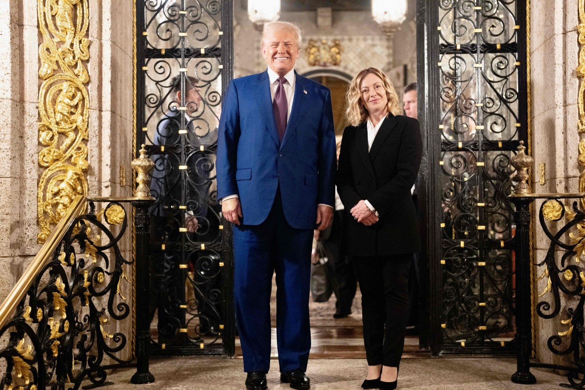 This handout picture released by the Palazzo Chigi press office on January 5, 2025 shows Italy's Prime Minister Giorgia Meloni posing with US President-elect Donald Trump at his Mar-A-Lago Club on January 4, 2025 in Palm Beach, Florida. (Photo by Filippo ATTILI / Palazzo Chigi press office / AFP)