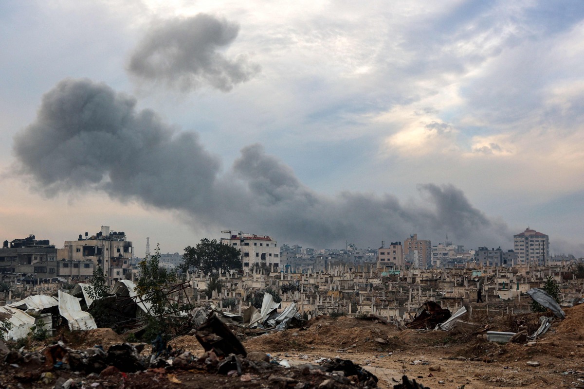 Smoke plumes billow during Israeli bombardment in the Saraya area in al-Rimal in central Gaza City on January 4, 2025. (Photo by Omar AL-QATTAA / AFP)
