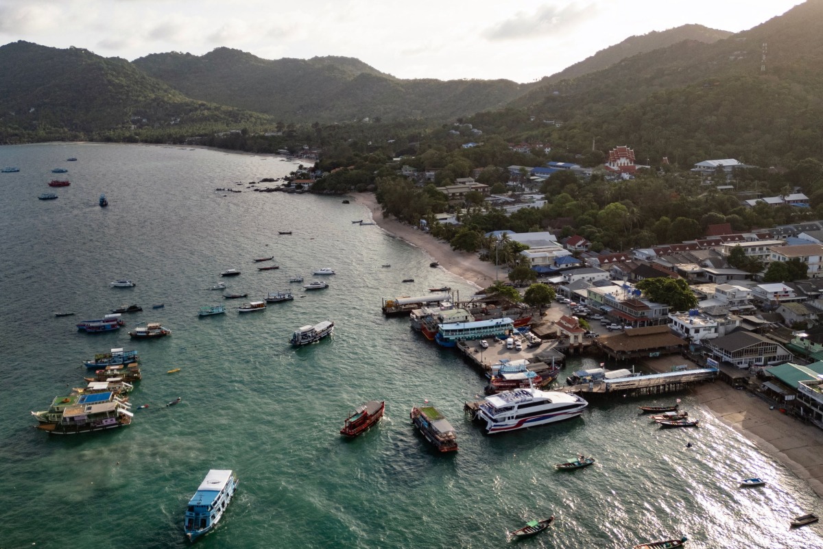 This aerial photo taken on June 15, 2024 shows tourist and fisher boats at Mae Head pier on Koh Tao island in the southern Thai province of Surat Thani. Photo by Lillian SUWANRUMPHA / AFP