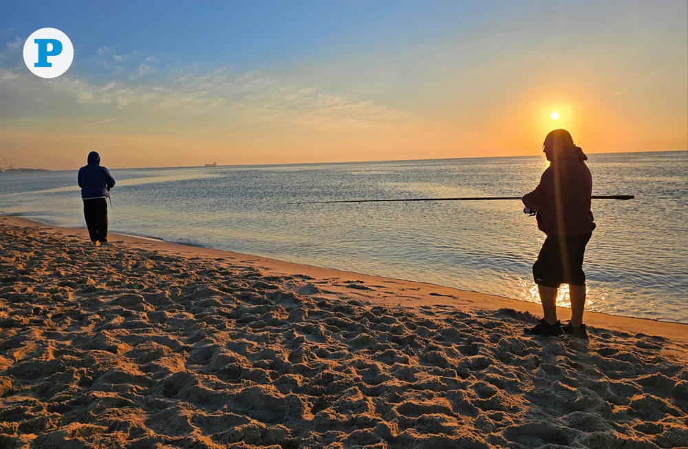 Two men enjoy a serene winter morning of fishing as the sun rises over Sealine in Mesaieed. (Photo by Marivie Alabanza / The Peninsula)