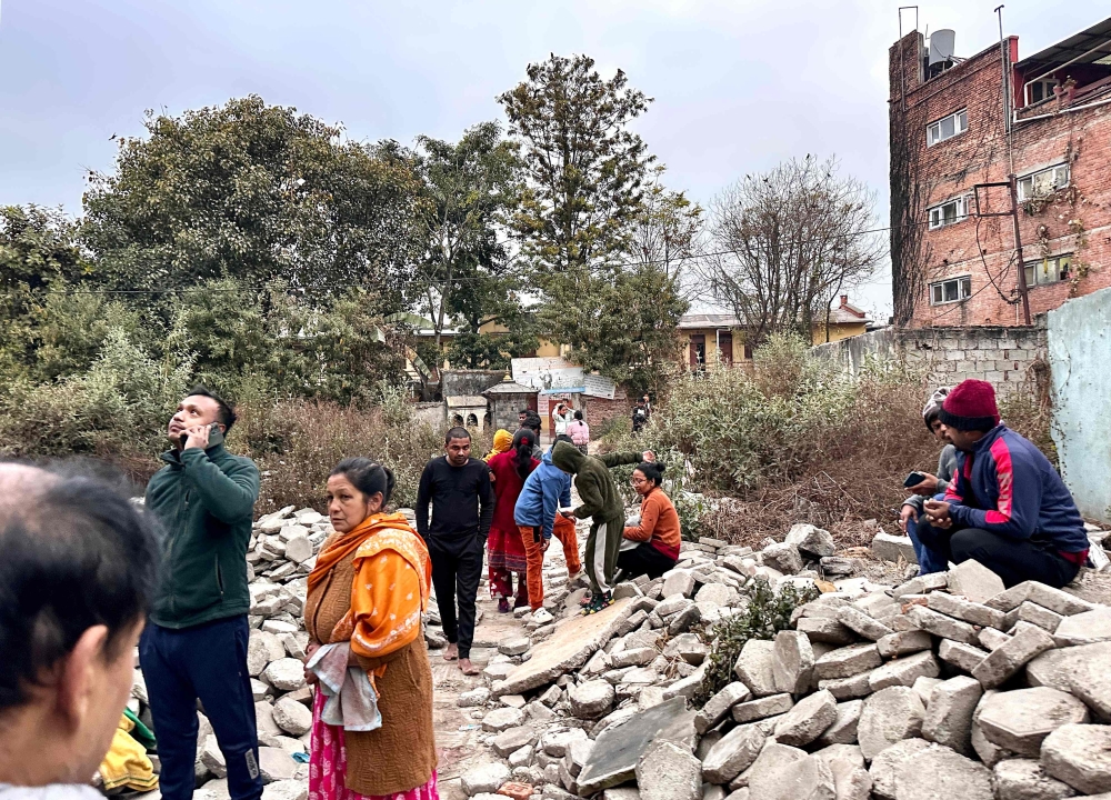 People gather in an open area following earthquake tremors in Kathmandu, in the early hours on January 7, 2025. (Photo by Sunil Sharma / AFP)