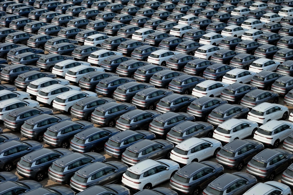 (Files) This photo taken on April 18, 2024 shows BYD electric cars for export waiting to be loaded onto a ship at a port in Yantai, in eastern China's Shandong province. (Photo by AFP) 