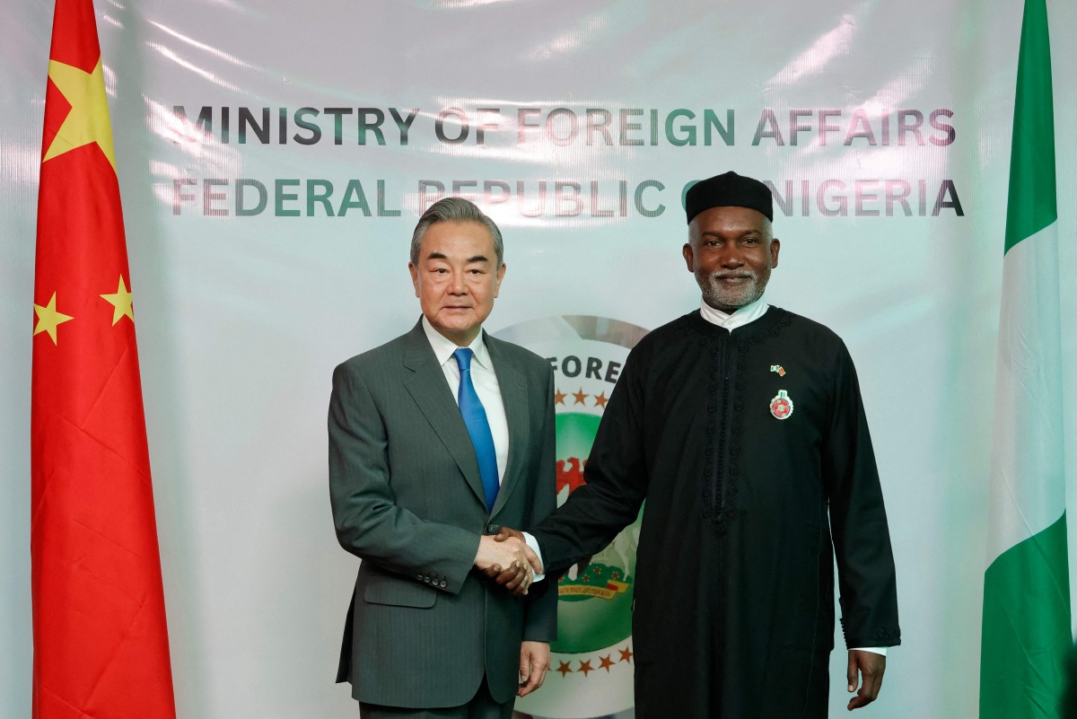 Chinese Foreign Minister Wang Yi (L) shakes hands with Nigeria's Foreign Affairs Minister Yusuf Tuggar (R) during Minister Wang's diplomatic visit to Abuja on January 9, 2025. (Photo by Kola Sulaimon / AFP)
