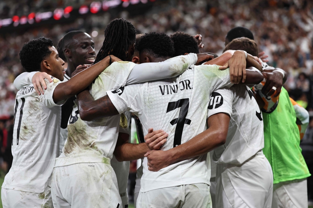 Real Madrid's players celebrate their first goal during the Spanish Super Cup semi-final football match between Real Madrid and Mallorca at the King Abdullah Sport City in Jeddah on January 9, 2025. (Photo by Fadel Senna / AFP)